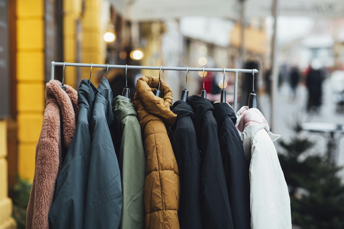 A rail of jackets in different weights, with a soft fleece hanging at one end