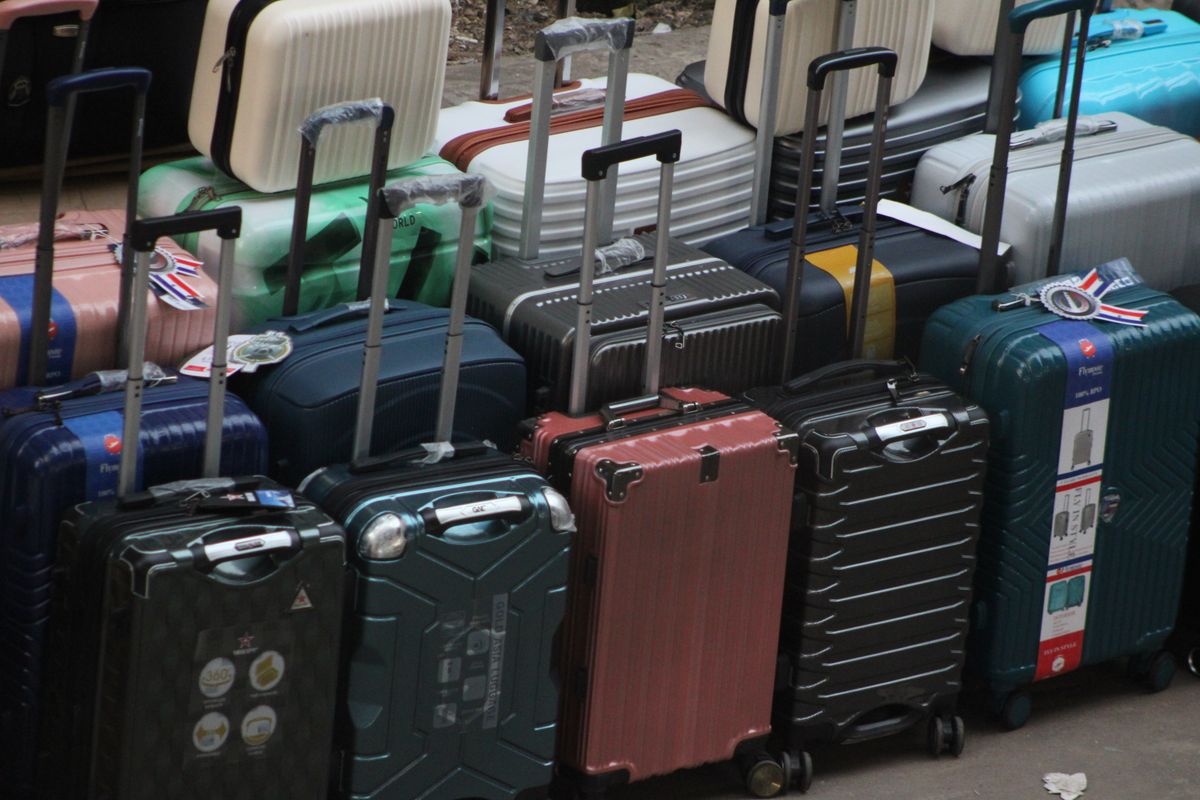 A hard-shell suitcase and a soft-shell case standing side by side on a floor